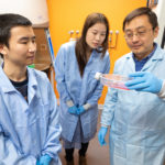 Visiting student Xin Chen (left),and Pharmaceutics PhD Lyrialle Han (center) look at cell samples with Qingcheng Mao.