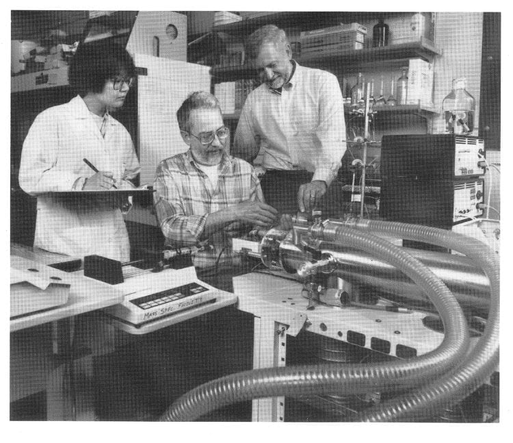 Bill Howald (pictured center) in the Mass Spec lab with then graduate student Shimako Oishi and former Dean Sid Nelson.