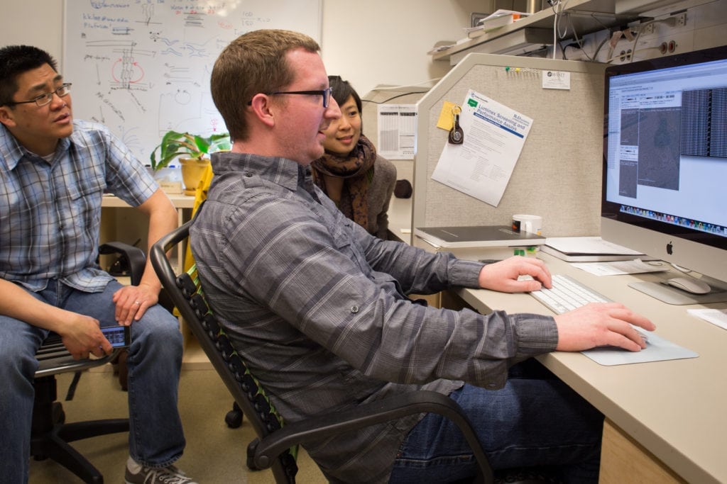 The Lee lab team at work decoding the influenza virus’ secrets (from L to R: Associate Professor Kelly Lee, James Williams, and Nancy Horn, PhD).