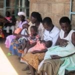 Women and their children await medical care at a clinic.