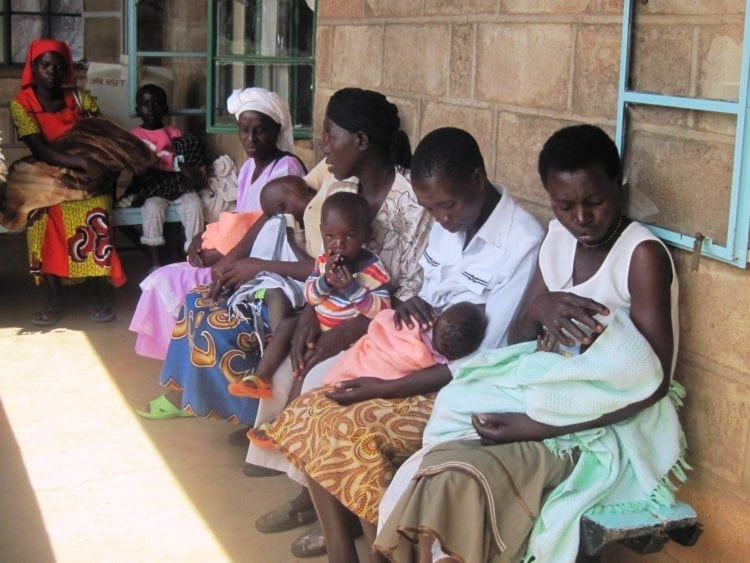 Women and their children await medical care at a clinic.