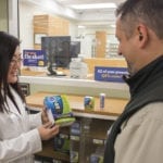 A local pharmacist counsels a client on the monitoring of blood sugar and the appropriate use of glucose tablets as part of diabetes self-care.
